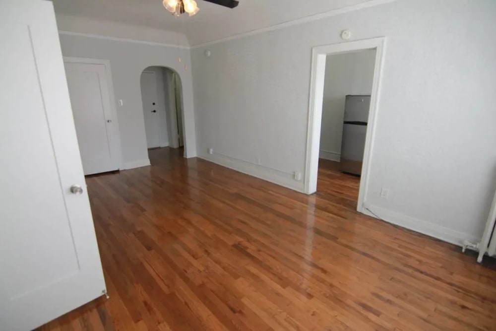 Living room with wood flooring with attached fan at Westmoreland Apartments in Los Angeles, California