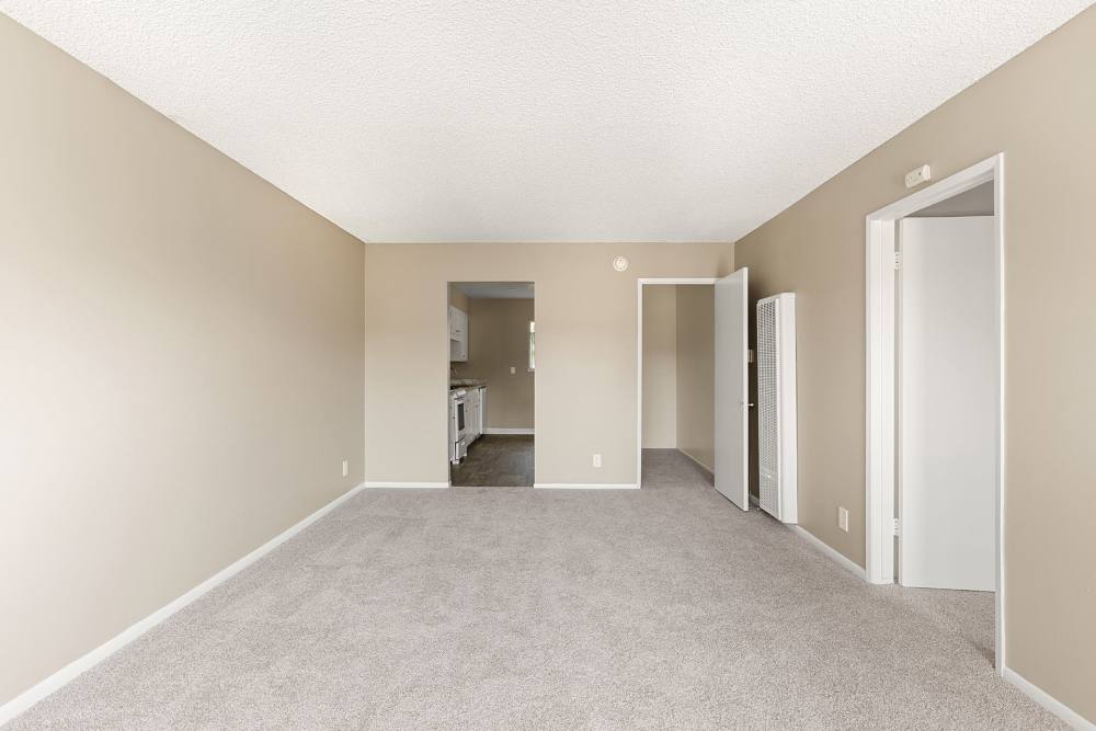 Spacious living room with carpeted flooring at Reseda Village Green in Reseda, California