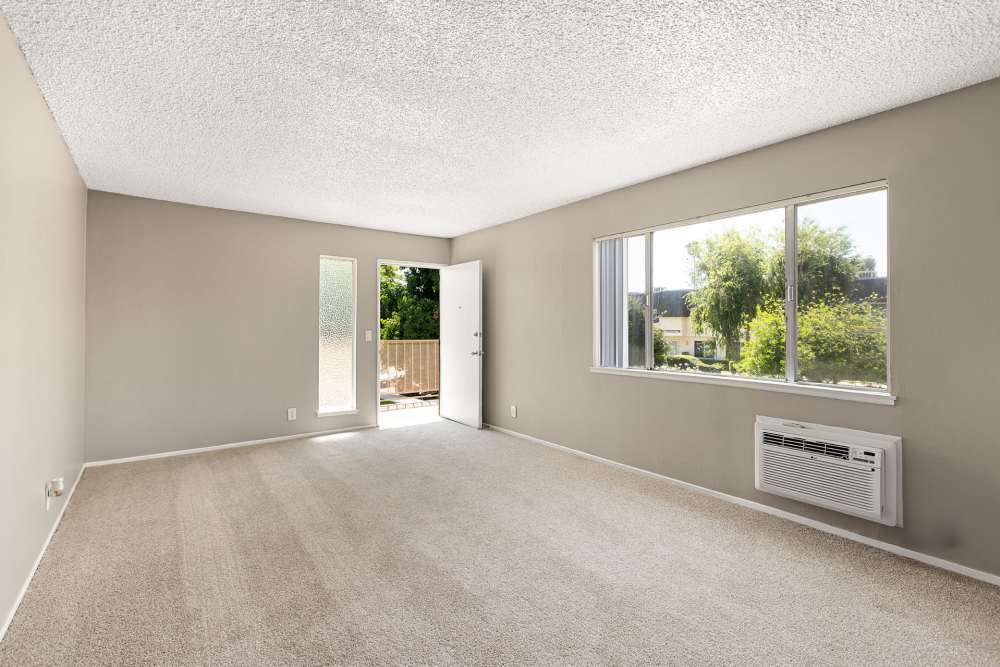 Living room with window in a model apartment at Reseda Village Green in Reseda, California