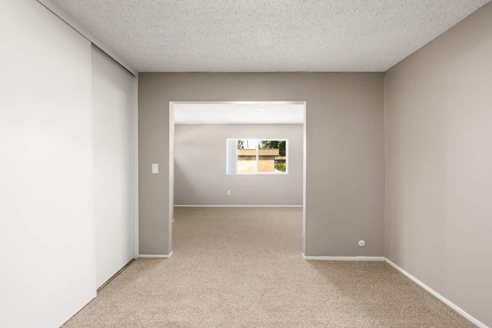Spacious living room with plush carpeting at Reseda Village Green in Reseda, California