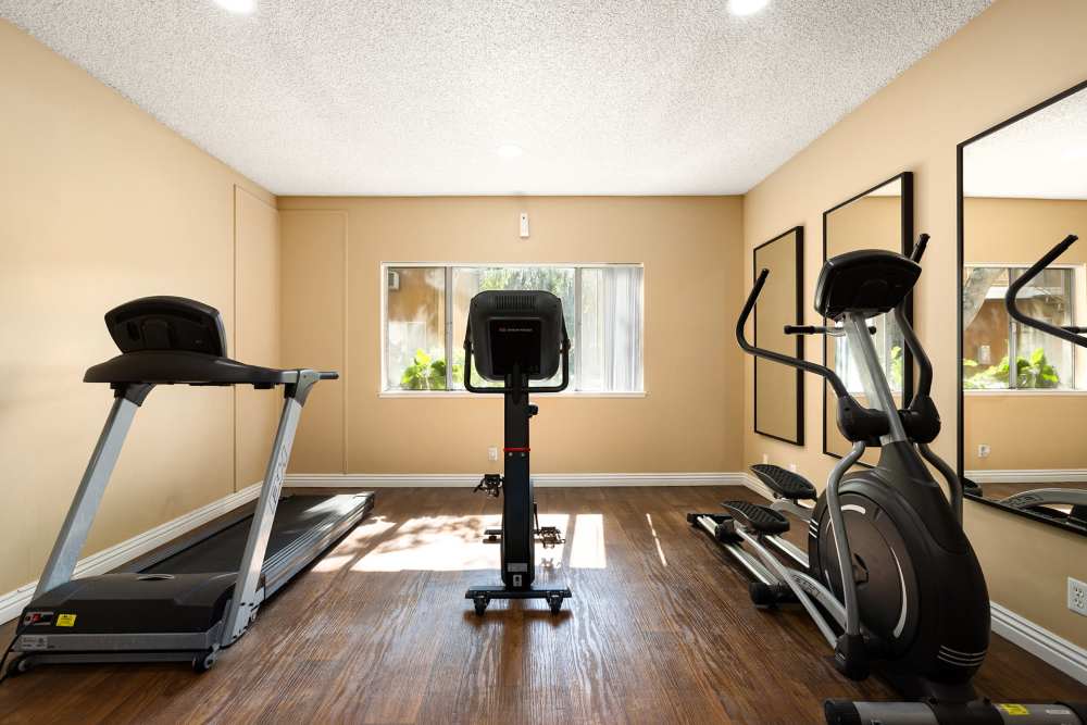 Fully-equipped gym with treadmills at Reseda Village Green in Reseda, California