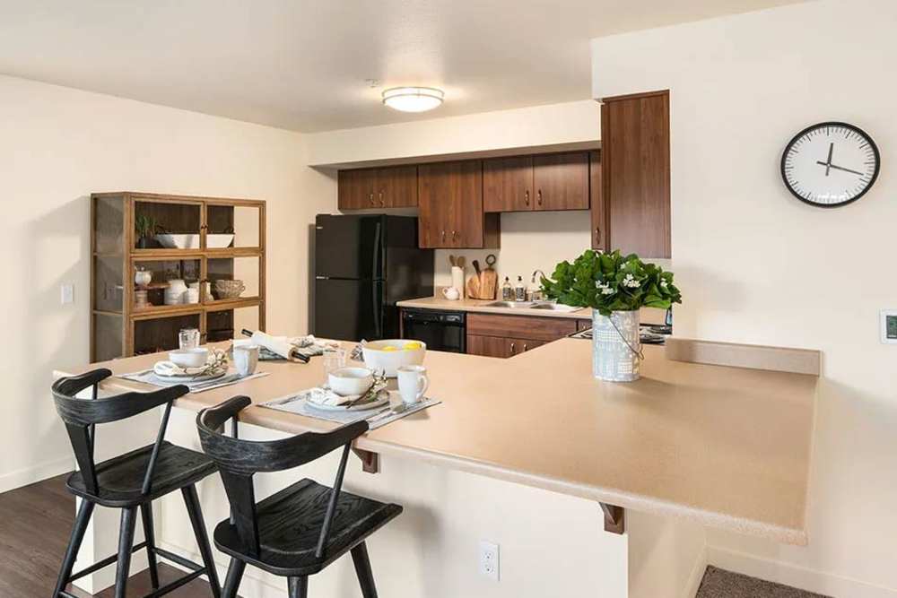 Open kitchen with bar counter at Traditions at Federal Way in Federal Way, Washington