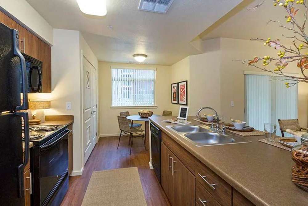 Kitchen with black appliances and dining area at Copper Mountain in Richland, Washington