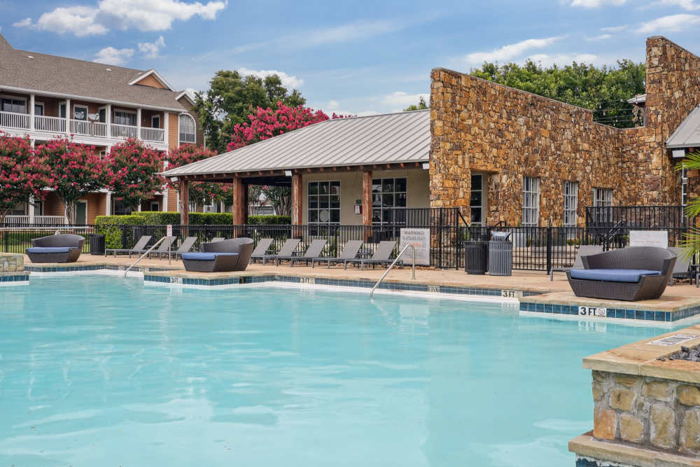 Swimming pool and lounge beds at Flatiron District at Austin Ranch in The Colony, Texas