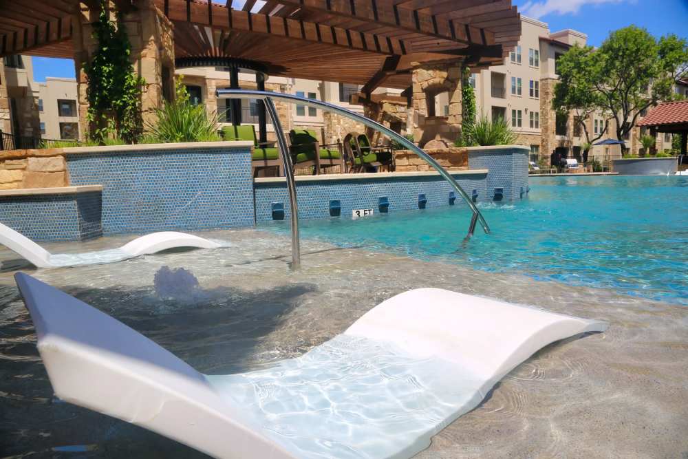 Pool deck with furniture at MELA in San Antonio, Texas