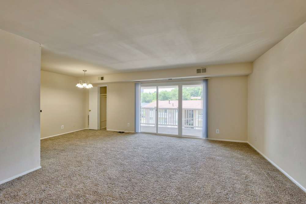 Spacious living space with a glass door at Heather Hill Apartments in Temple Hills, Maryland