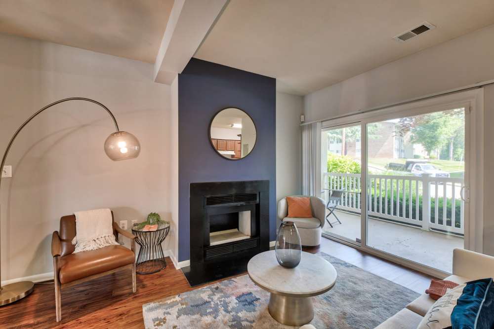 Fully furnished living space with a wood burning fireplace at Heather Hill Apartments in Temple Hills, Maryland