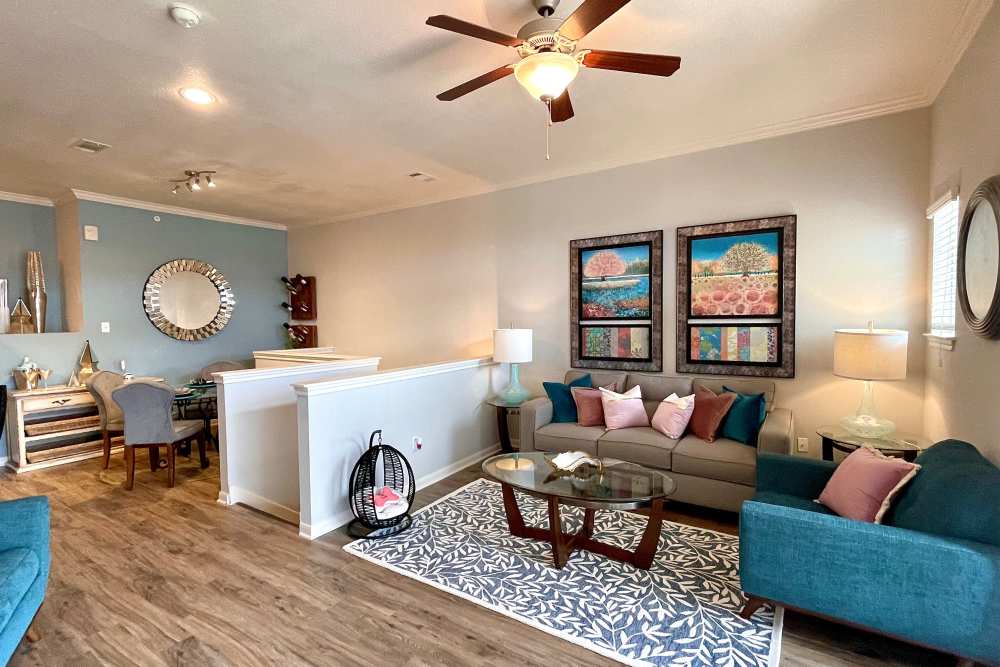 Cozy living room with a view of the dining area at The Abbey at Stone Oak in San Antonio, TX