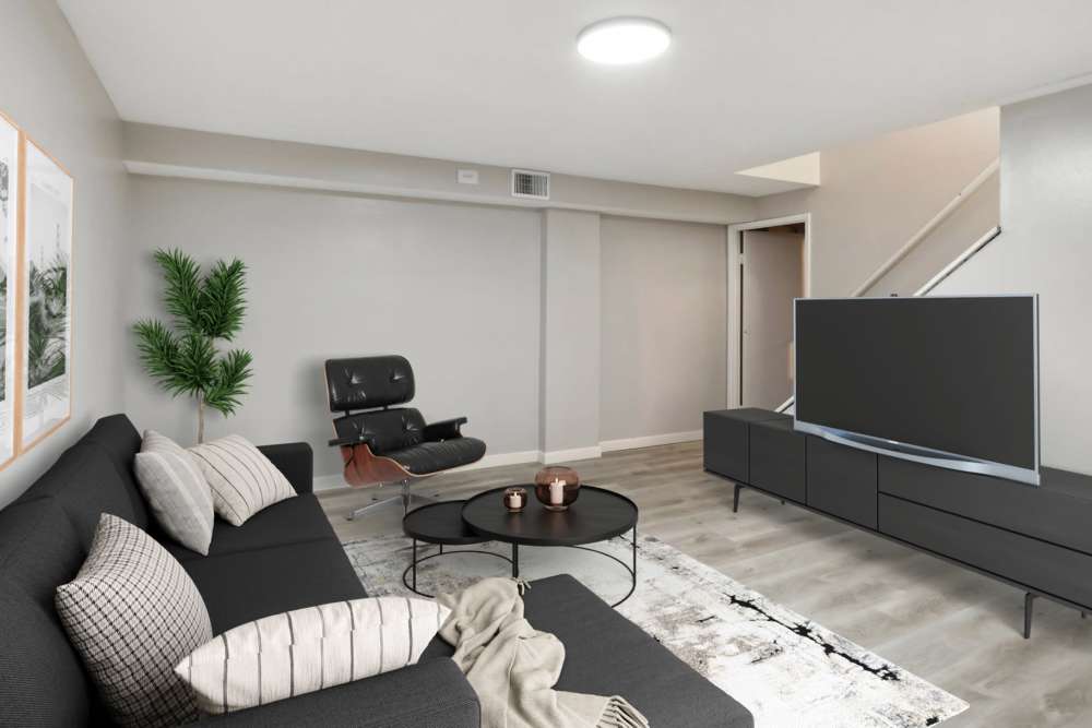 Living room with a large TV at North Eden Townhomes in Columbus, Ohio