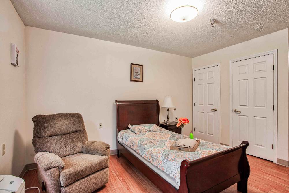 Bedroom with chair Clemmons Village Assisted Living and Memory Care in Clemmons, North Carolina