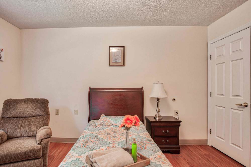 Bedroom with nightstand Clemmons Village Assisted Living and Memory Care in Clemmons, North Carolina