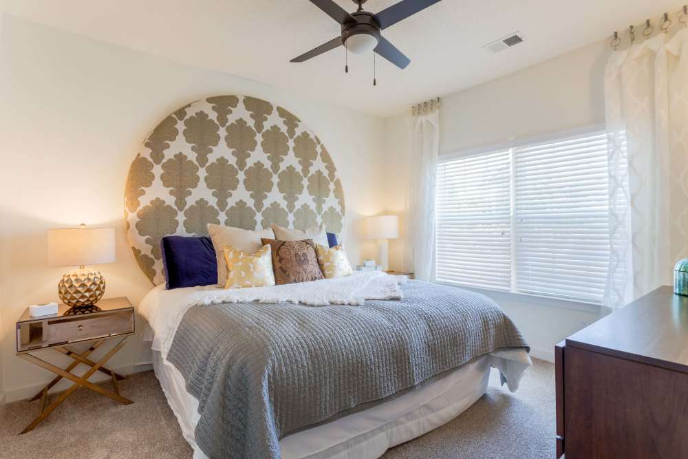 Bedroom with patterned headboard and plush bedding at Springfield Apartments in Murfreesboro, Tennessee