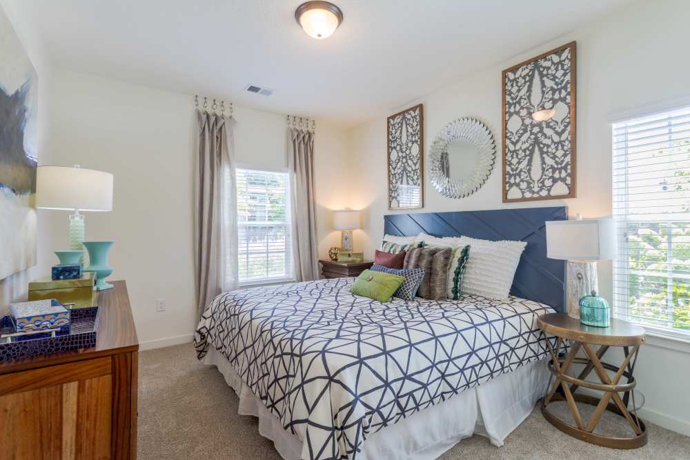 Bedroom with navy accent wall and patterned bedding at Springfield Apartments in Murfreesboro, Tennessee