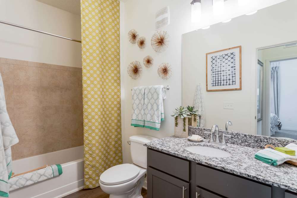 Bathroom with tub and tile surround at Springfield Apartments in Murfreesboro, Tennessee