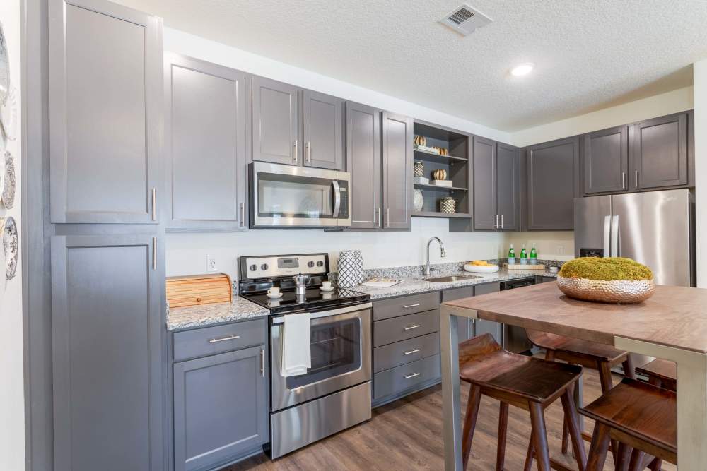 Kitchen with stainless steel range and bar seating at Springfield Apartments in Murfreesboro, Tennessee