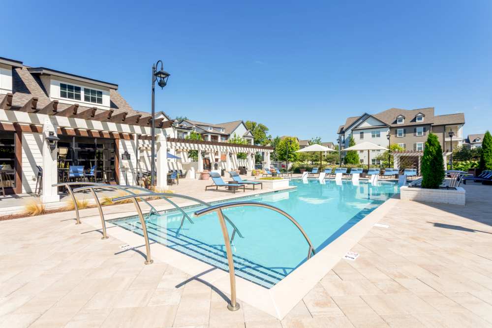 Pool deck with lounge chairs and pergola at Springfield Apartments in Murfreesboro, Tennessee