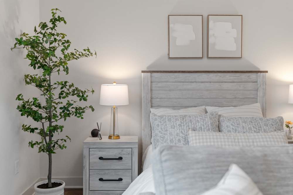 Model unit bedroom with end table at Amira Choice Arvada in Arvada, Colorado