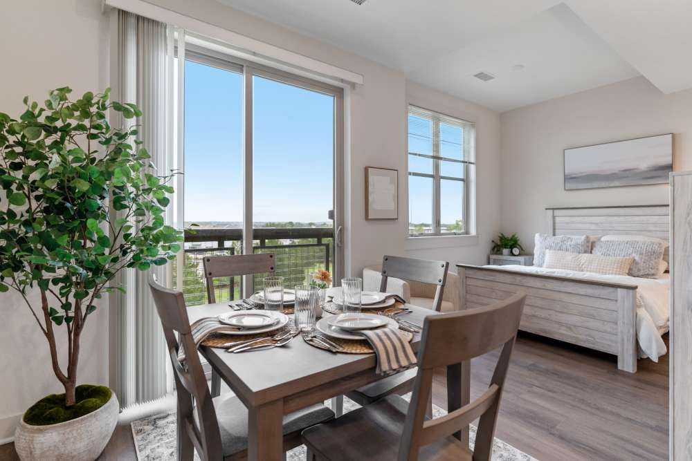Model unit bedroom and dining area at Amira Choice Arvada in Arvada, Colorado