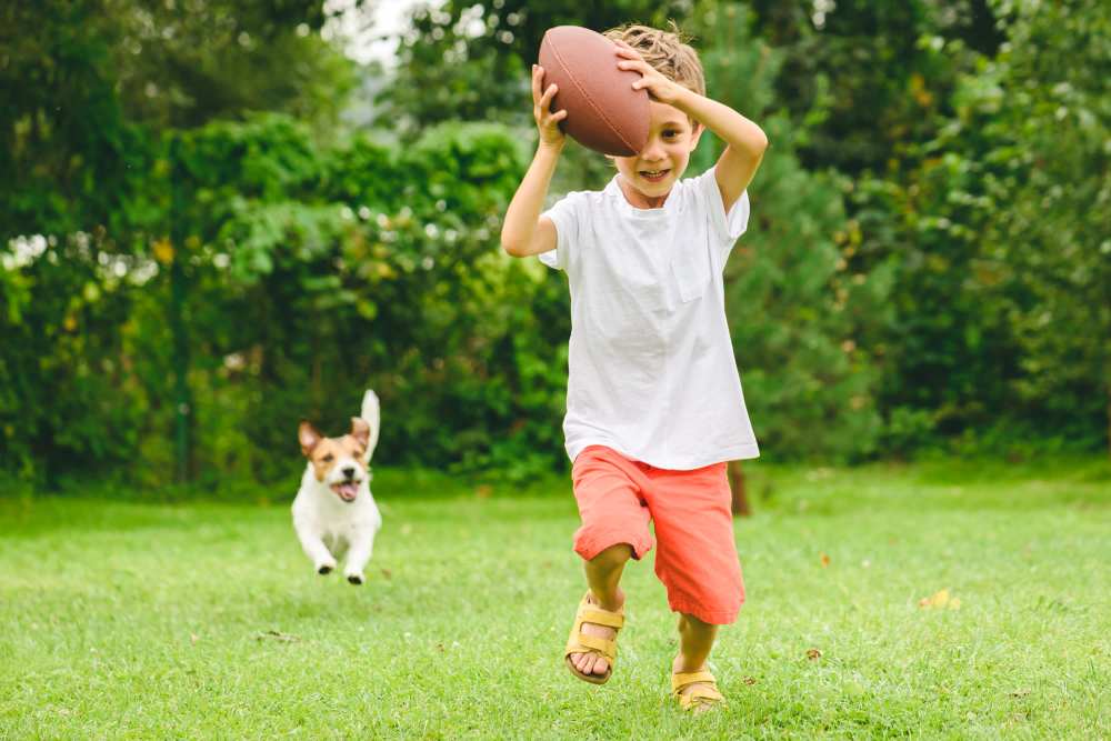 Dog chasing a child with a ball at Columbine Apartments in Littleton, Colorado