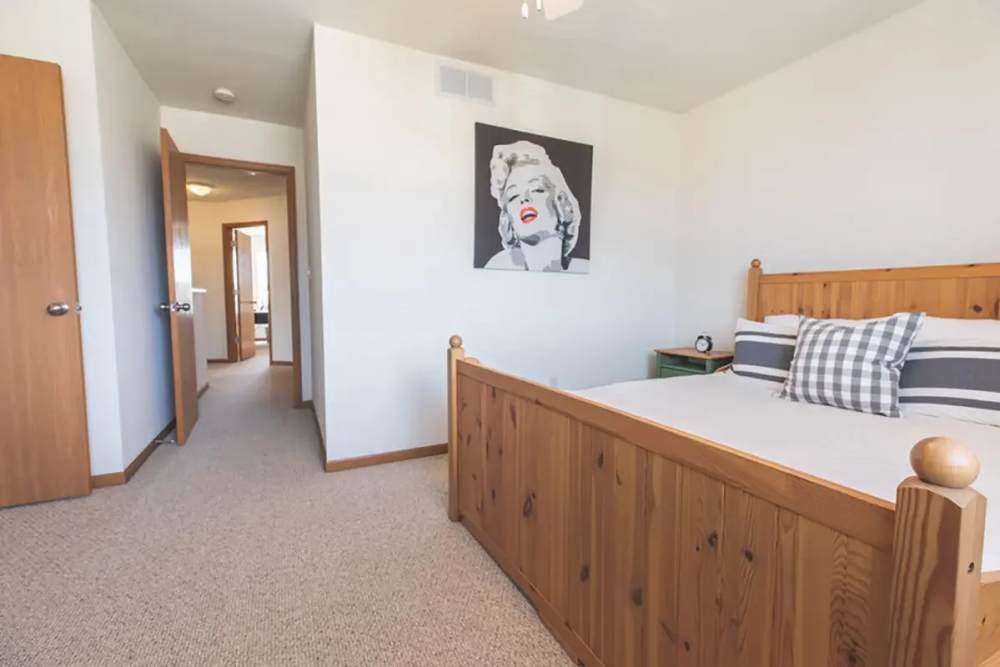 Modern bedroom with wooden style flooring at Cross Creek Villas in Columbia, Missouri