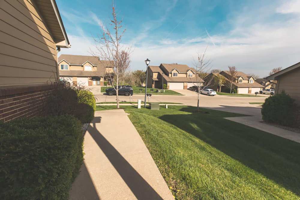 View of exterior of homes and green lawn at Cross Creek Villas in Columbia, Missouri, 