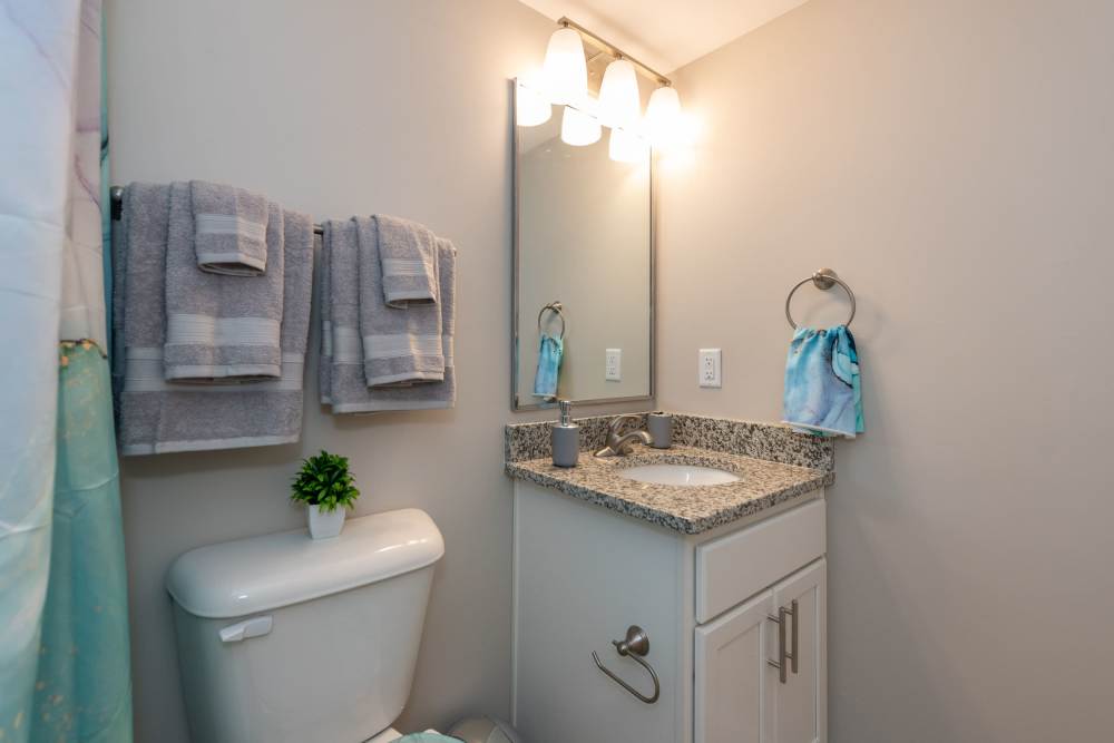 Bathroom with warm lamp lights at Attain at Chic’s Beach, Virginia Beach, Virginia