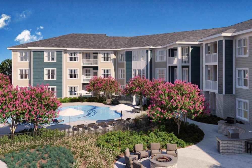 Outdoor apartment view with green landscaping at Attain at Chic’s Beach, Virginia Beach, Virginia