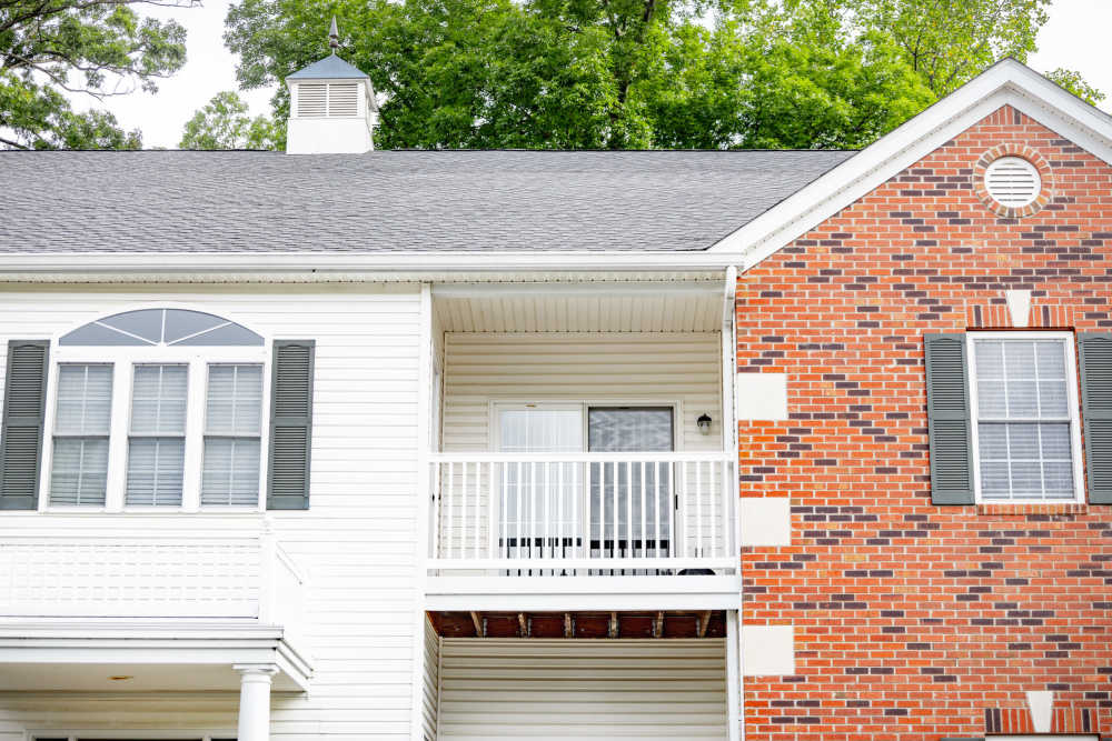 Patio and balcony with a glass windowed door at  Forest Ridge in Bloomington, Indiana, 