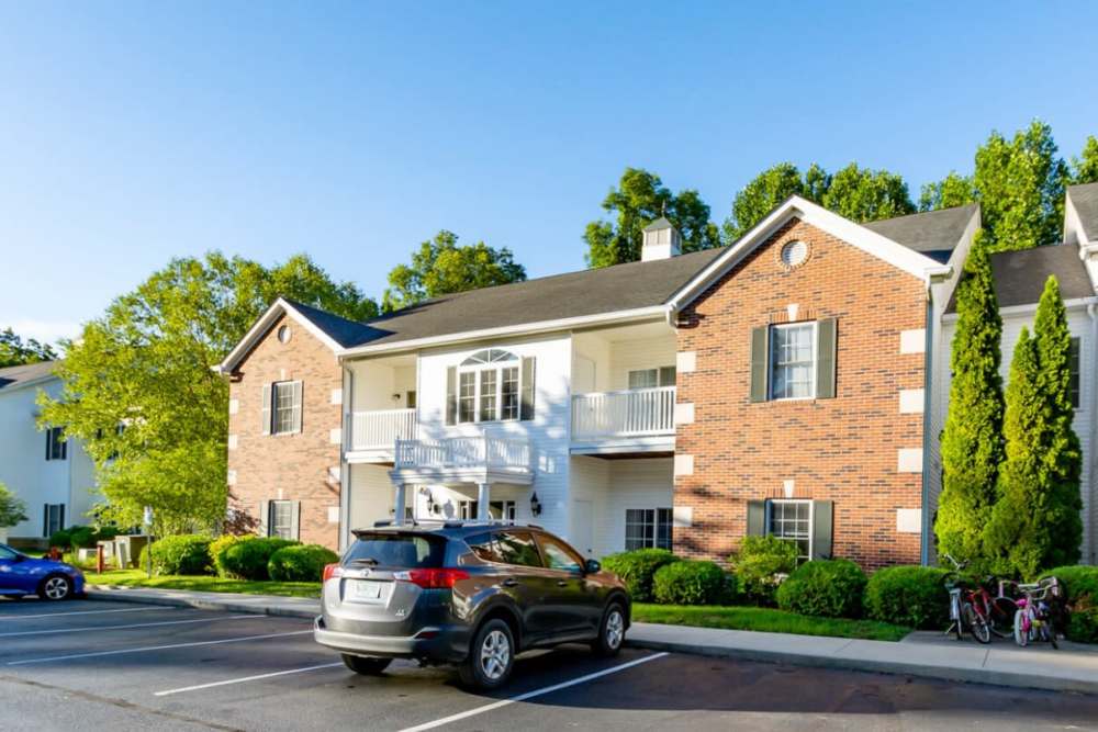 View of exterior of community and green lawn with lot of trees at Forest Ridge in Bloomington, Indiana, 