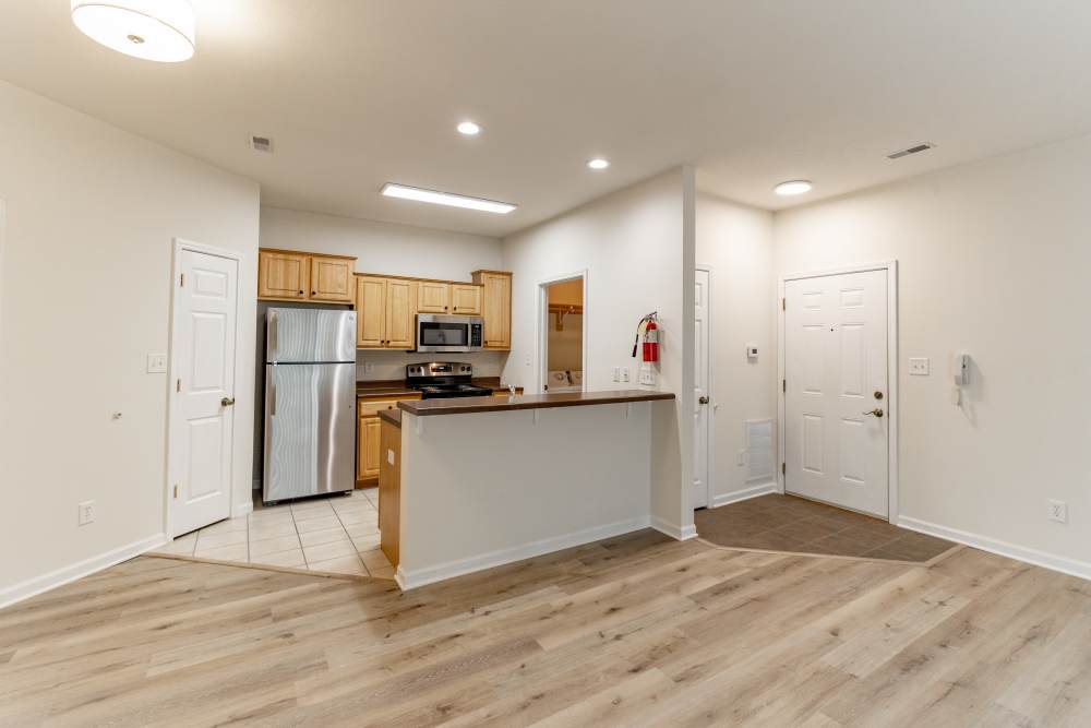 Whole view of open kitchen connected to living room at Forest Ridge in Bloomington, Indiana, 