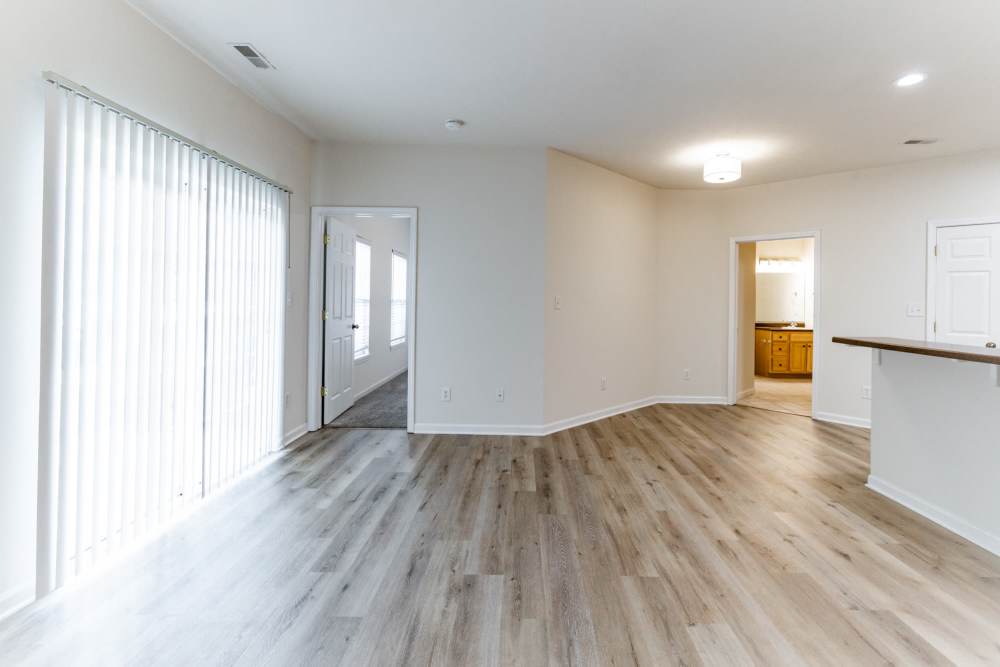 Spacious living room with large windows and connected to kitchen at Forest Ridge in Bloomington, Indiana, 