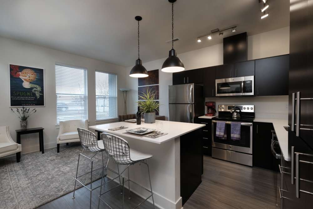 Spacious kitchen and living room with wood-style flooring at 27 Elm in Redmond, Oregon