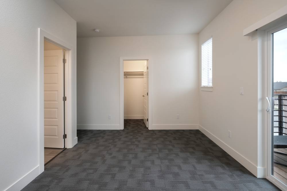 Bedroom with access to private balcony at 27 Elm in Redmond, Oregon