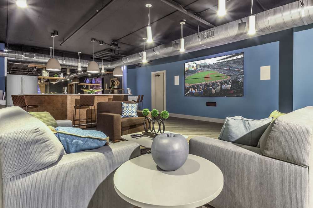 Community seating area with a flat-screen TV at Greenside in Charlotte, North Carolina