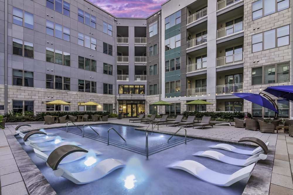 Swimming pool with multiple lounge chairs at Greenside in Charlotte, North Carolina