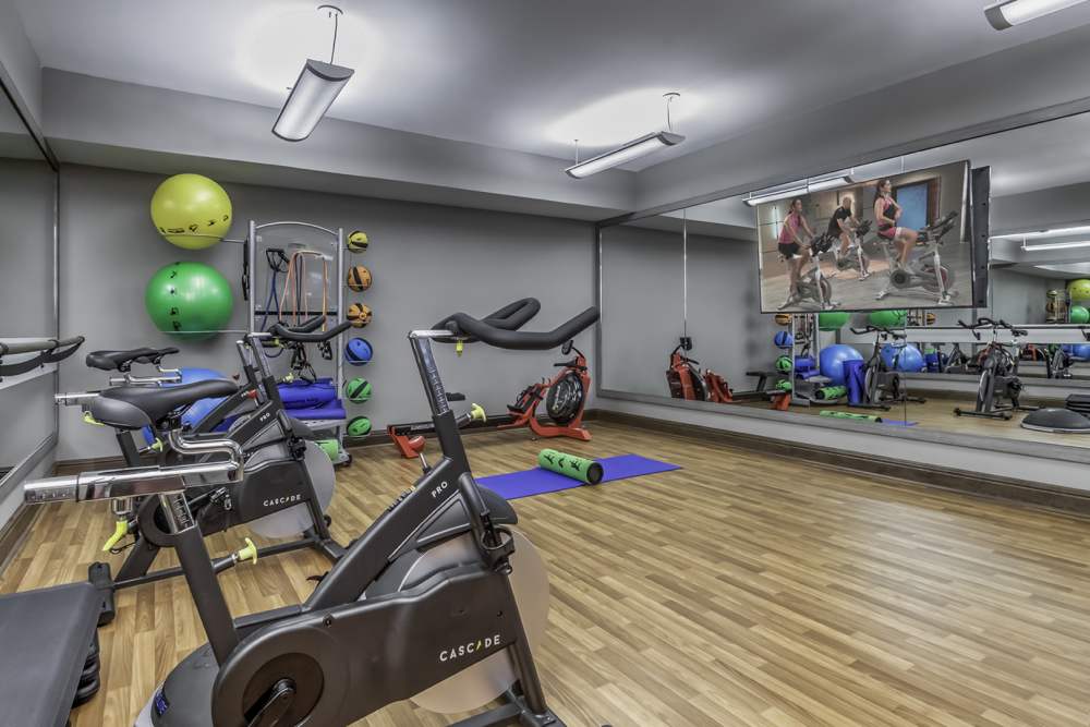Spacious fitness center with a large mirror at Greenside in Charlotte, North Carolina