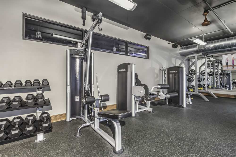 well-equipped fitness center with multiple weights at Greenside in Charlotte, North Carolina