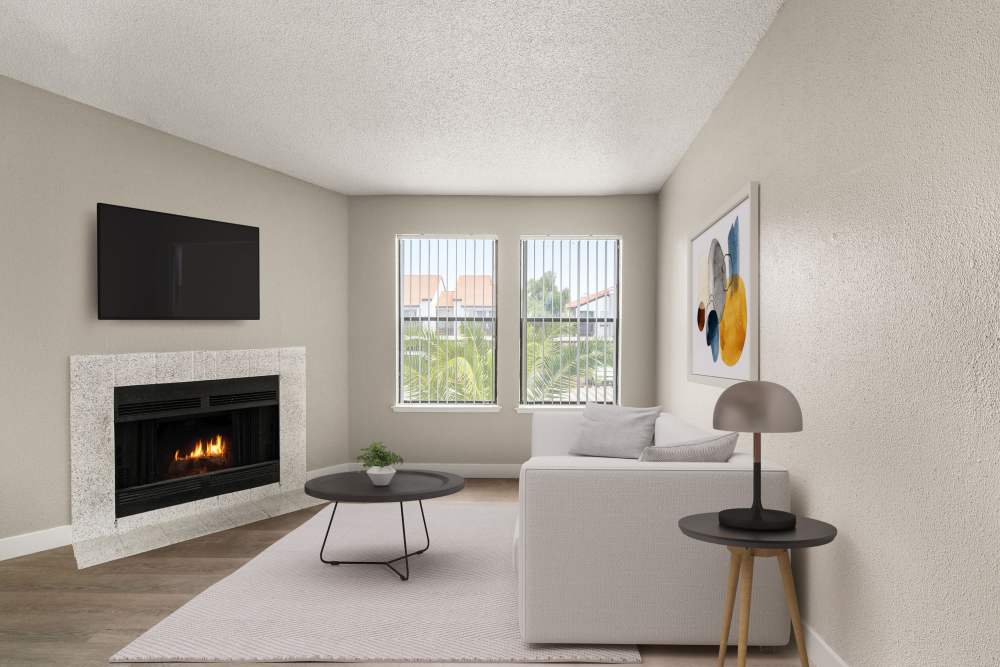 Model unit living area with fireplace and large window at Cielo on Gilbert in Mesa, Arizona