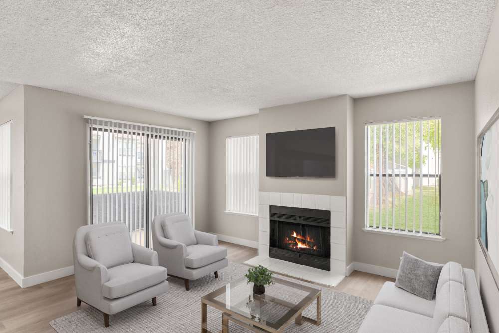 Model unit living area with sofa and fireplace at Cielo on Gilbert in Mesa, Arizona