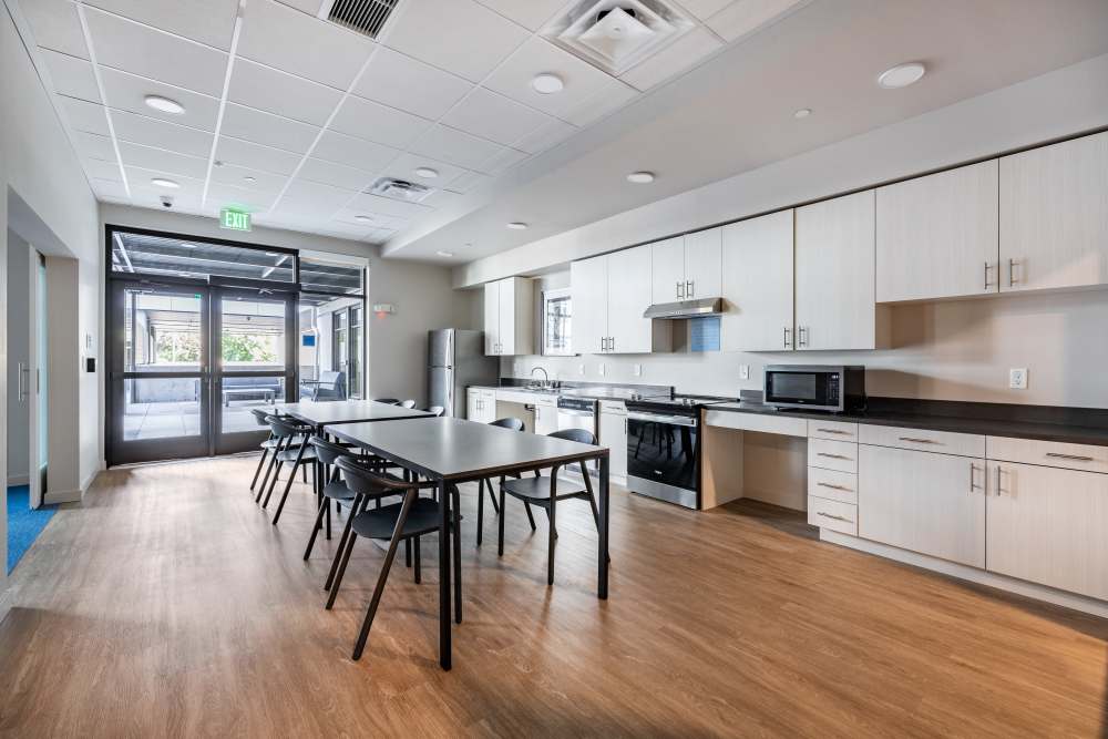 Fully equipped community kitchen with seating at Traditions at Hazelwood in Portland, Oregon