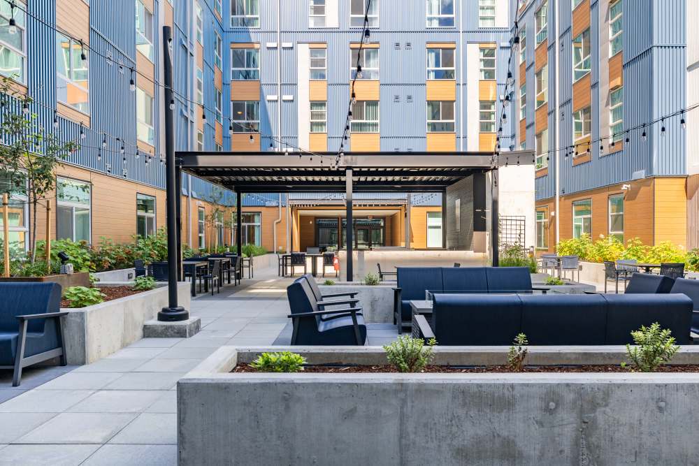 Community courtyard wit PingPong Table, BBQs, Seating, and Fire pit  at Traditions at Hazelwood in Portland, Oregon