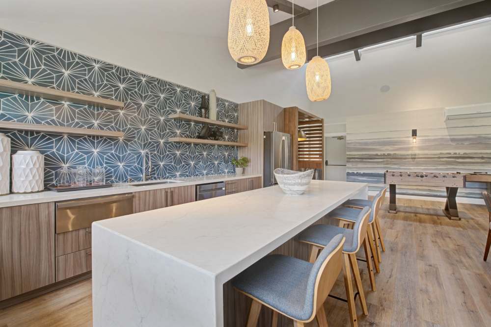 Spacious kitchen in clubhouse with foosball game setup at Sofi Ventura in Ventura, California