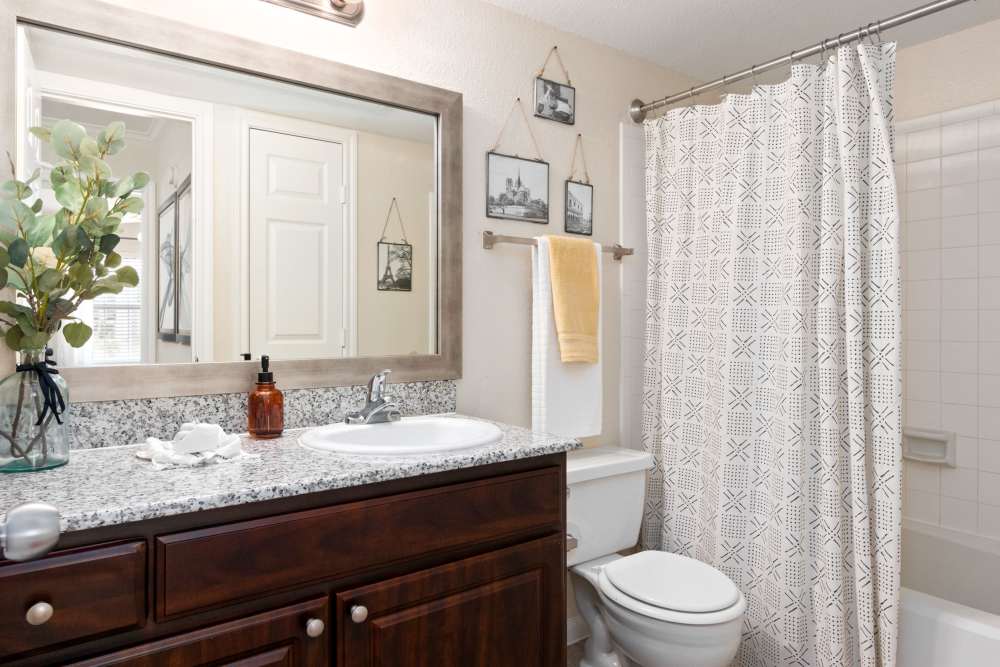 Bathroom with granite counter top  at The Abbey At Enclave in Houston, Texas