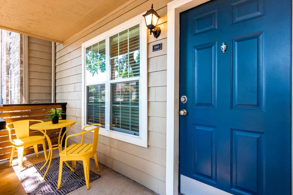 Patio with yellow chair and table  at The Abbey At Enclave in Houston, Texas