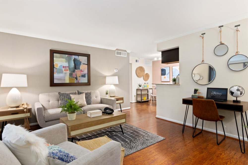 Living room with three seater sofa and working table  at The Abbey At Enclave in Houston, Texas 