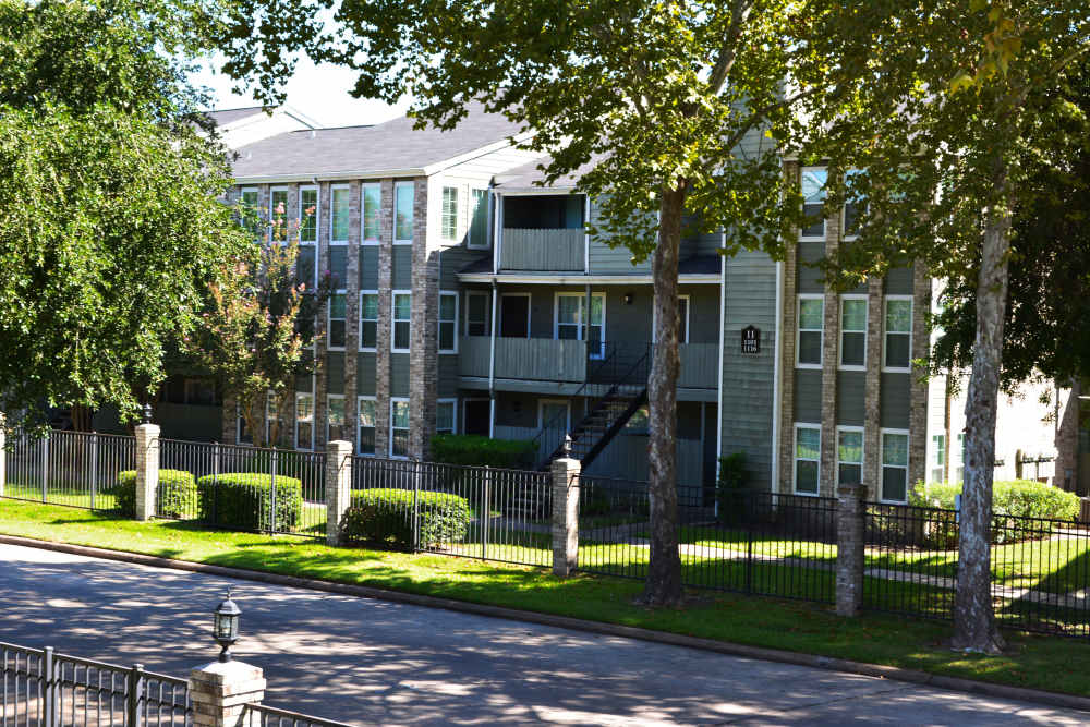 Exterior view of building with roadside view  at The Abbey At Enclave in Houston, Texas