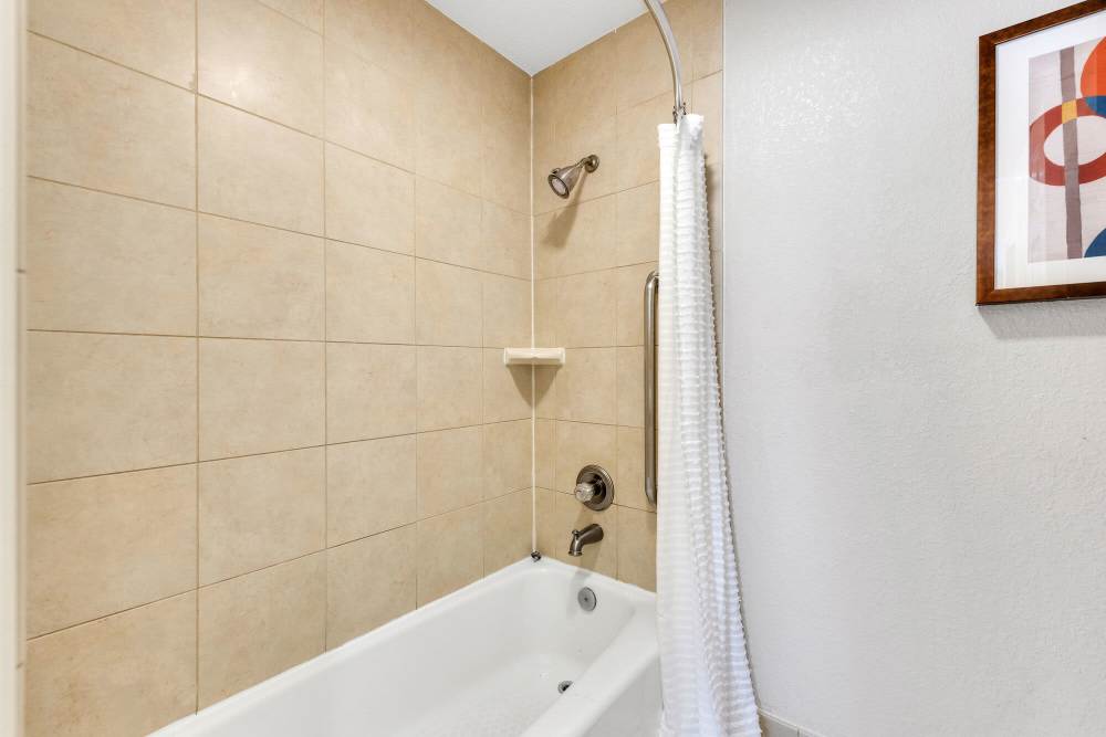 Bright bathroom with shower and tub at Vivo Living Charlotte in Charlotte, North Carolina, 