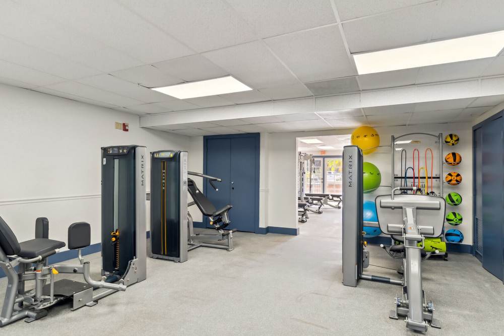 Fitness center with carpet flooring at Vivo Living Kissimmee in Kissimmee, Florida