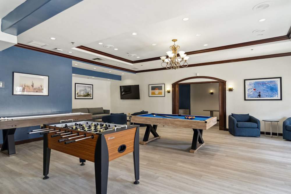 Play room with foosball and billiard table at Vivo Living Kissimmee in Kissimmee, Florida