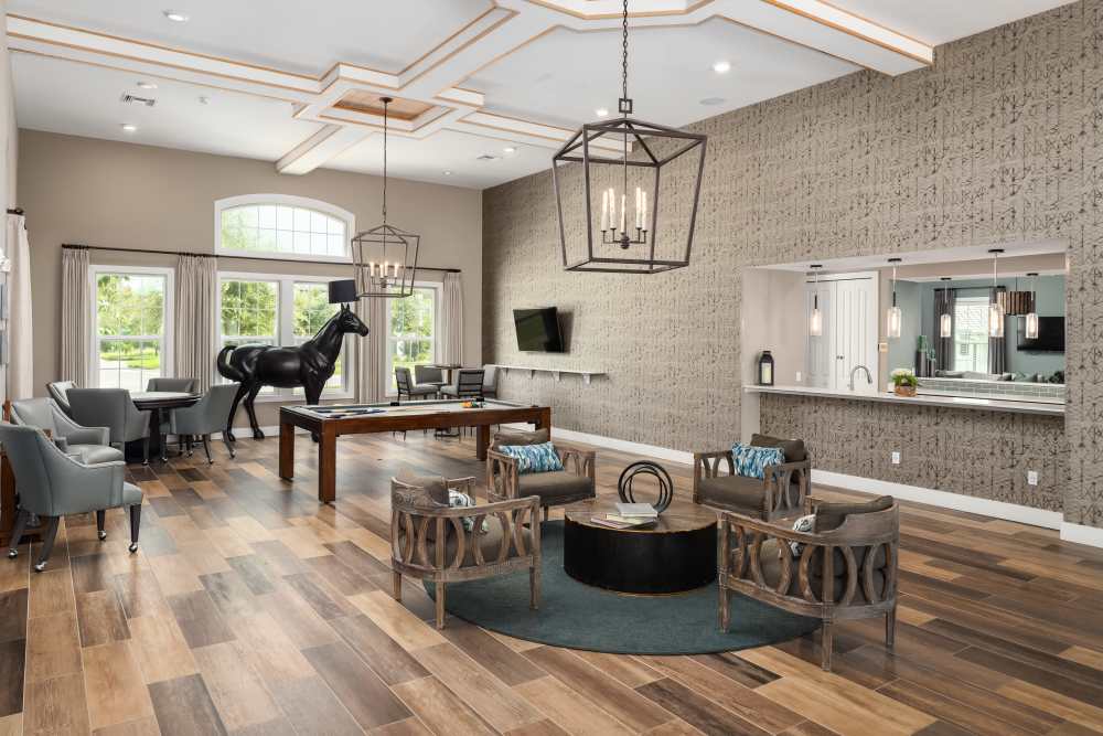 Community lounge area with tables and lots of seating at Shadetree Apartments in Ruskin, Florida